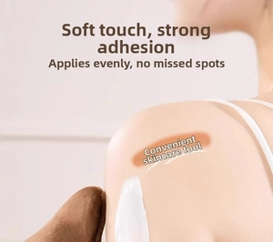 Macro detail of soft tanning mitt applying lotion smoothly on shoulder skin