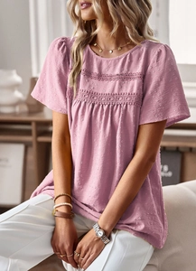 Detailed view of pink short-sleeve top featuring intricate lace texture and round neckline