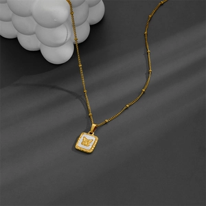 Elegant gold square medallion necklace with white shell inlay and butterfly relief