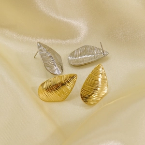 Irregular striped waterdrop earrings in gold and silver finish on silk background