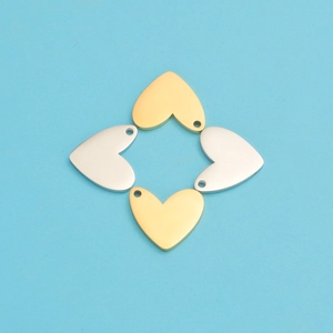 Macro shot of gold and silver heart-shaped metal charms for DIY jewelry making