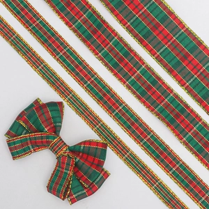 Macro detail of red and green plaid Christmas ribbon with gold edges in five widths
