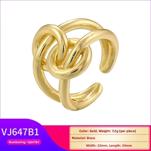 Detailed view of irregular geometric braided golden brass ring measuring 22mm by 24mm