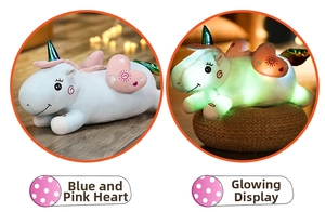 Details of glowing unicorn plush toy pillow showing blue pink heart style and glow effect