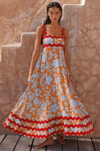 Detail of bohemian floral maxi dress featuring red rickrack trim and cotton linen texture