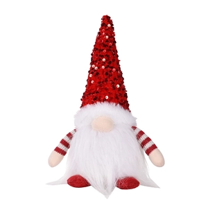 Close-up of a Christmas gnome doll with sequins and warm glowing light effect