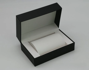 Detail of black PU leather watch box with white soft pillow and hinged lid interior
