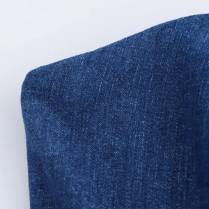 Primo piano della trama del tessuto denim blu a pieghe e dell'intreccio indaco