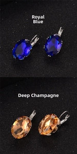 Detailed close-up of oval cut crystal leverback earrings in royal blue and deep champagne