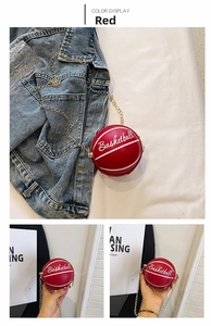 Detail of red basketball shaped mini bag with white script and gold chain strap