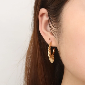 Elegant gold angel wing C-shaped hoop earrings for women shown on model for daily wear