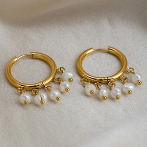 Detailed macro view of 18K gold plated hoop earrings with five freshwater pearls