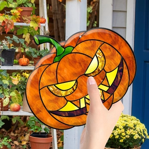 Close-up of a decorative Halloween pumpkin pendant with colorful acrylic stained glass texture