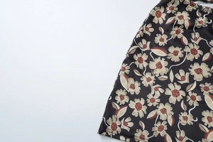 Close-up of floral print pattern on a high waist slim fit skirt with black base color