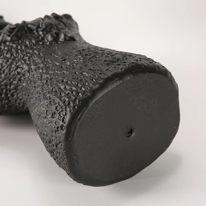 Macro view of black resin jewelry stand showing detailed texture and skin-like pattern