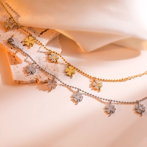 Gold and silver clover charm beaded chain bracelet with pavé cubic zirconia accents