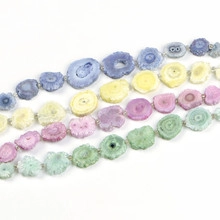 Detailed view of four colorful 6mm faceted natural stone bracelets in blue, yellow, pink, and green