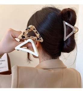 Close-up of geometric triangle hair claws in tortoiseshell, cream and grey finishes
