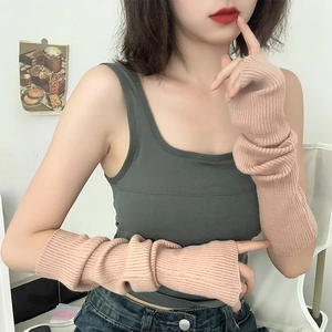 Detail of soft lotus pink knitted arm sleeves with fingerless design and ribbed texture