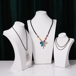 Elegant white necklace display stands with crystal butterfly and fish pendant jewelry