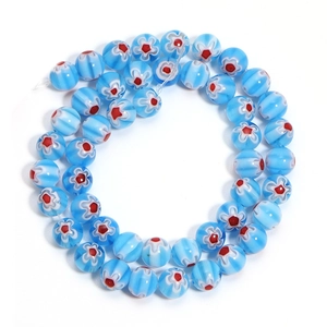 Macro shot of sky blue Millefiori glass beads with striped patterns and floral details