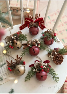 Detailed close-up of festive Christmas bells with pine cones and red berries on a wooden seat