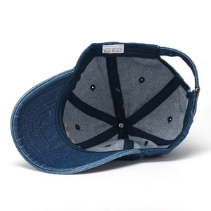 Internal view of denim baseball cap featuring 100% cotton stitching and adjustable metal buckle