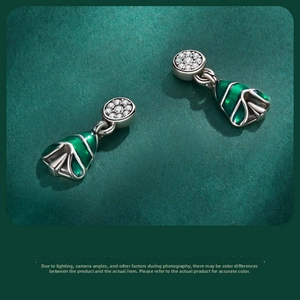 Detailed close-up of S925 sterling silver Christmas tree earrings with green enamel and pavé diamonds