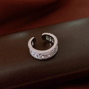 Macro detail of adjustable silver ring with pave-set white cubic zirconia stones