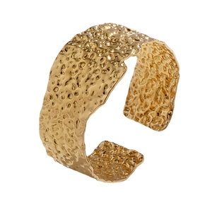 Minimalist wide gold-plated stainless steel cuff bracelet with irregular lava texture