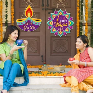 Colorful Diwali hanging decorations with 'HAPPY Diwali' text on a traditional door setup