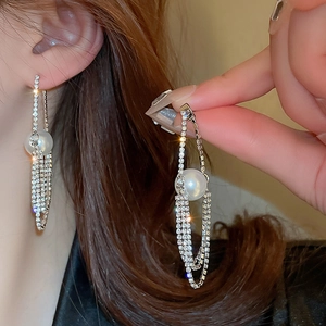 Elegant long tassel drop earrings with sparkling crystals and a white faux pearl