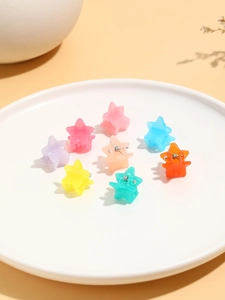 Detailed view of eight mini star-shaped hair claws in assorted pastel jelly colors