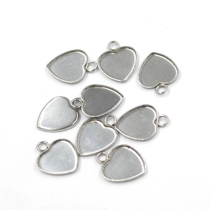 Macro view of heart-shaped metal pendant bases for DIY jewelry making accessories