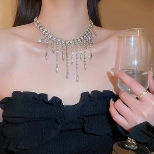 Detailed close-up of a silver rhinestone tassel choker necklace with elegant sparkling crystals