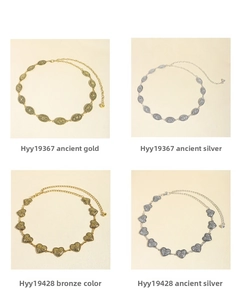 Detailed view of antique gold and silver relief engraved metal belts in oval and heart shapes