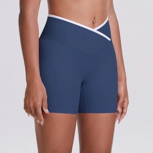 Detail of high-waisted navy yoga shorts with V-shaped cross waist and white contrast trim
