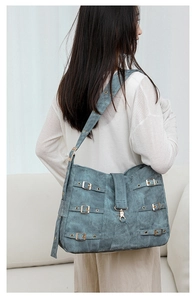 Close-up of vintage large tote with washed texture and silver metal buckle details