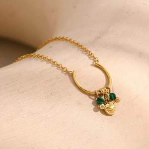 Detailed close-up of 18K gold-plated U-shaped necklace with heart charm and green malachite beads
