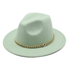 Detailed close-up of mint green fedora hat featuring a chunky gold metal chain trim