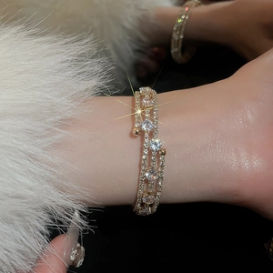 Detail view of gold layered bracelet with sparkling round cubic zirconia on model