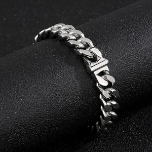 Macro view of polished silver cuban link chain bracelet with a secure box clasp