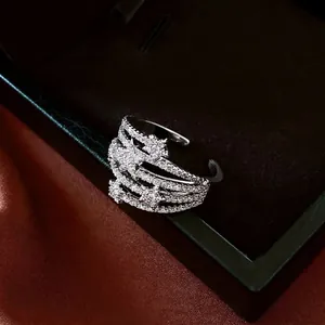 Layered star open ring with cubic zirconia on black jewelry box and red silk background