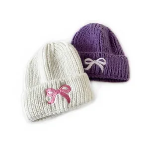 Cozy knit hats for kids with sweet bow embroidery in ivory and deep purple colors