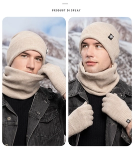 Detail of beige winter knit set including a beanie, scarf, and gloves with knit texture