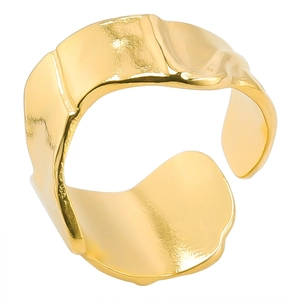 Detail of wide gold adjustable ring with irregular hammered texture and wavy edges