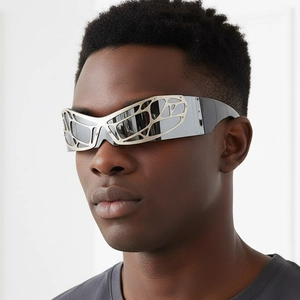 Y2K futuristic silver spiderweb wraparound sunglasses worn by a fashion model