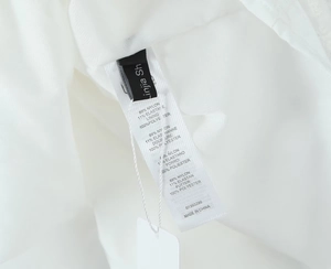Detail shot of care label showing 89% Nylon and 11% Elastane fabric composition