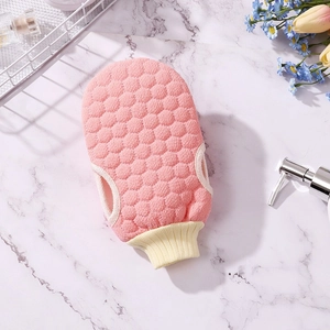 Pink honeycomb texture exfoliating shower glove with elastic wrist band and beige piping