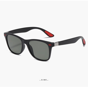Side view of black sports sunglasses with red anti-slip rubber pads and dark grey lenses